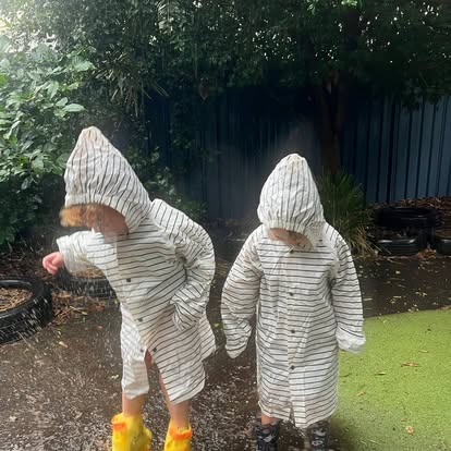 Children enjoying outdoor play in the rain at Lakeview Preschool